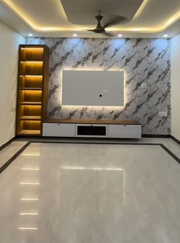 Modern TV unit interior design in Delhi with wall panel, LED lighting and storage cabinets